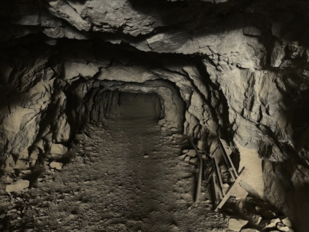 A black and white photo of an underground tunnel.